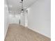 An open concept living room with plank flooring, white walls, and modern light fixtures at 14 S Forest St, Plant City, FL 33563