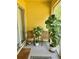 Cozy balcony with wicker chairs, plants, and a yellow wall at 3433 Dragon View Ct, Valrico, FL 33594