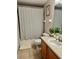 Bathroom with tiled floor, shower/tub combo, single vanity, and a large mirror at 3433 Dragon View Ct, Valrico, FL 33594