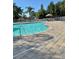 Community pool with lounge chairs and a paved deck area at 3433 Dragon View Ct, Valrico, FL 33594
