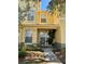 Inviting front exterior of a two-story townhome with a small porch and landscaping at 3433 Dragon View Ct, Valrico, FL 33594
