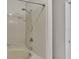 Clean bathroom with tub and shower, featuring updated tile at 6110 Downing St, Dover, FL 33527