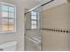 Bathroom with tiled shower, sliding glass door, and single vanity at 6110 Downing St, Dover, FL 33527