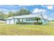 Newly built home with a metal roof, two-car garage, and manicured lawn at 6110 Downing St, Dover, FL 33527
