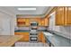 Kitchen boasts granite countertops, stainless steel appliances, and wood cabinets at 6110 Downing St, Dover, FL 33527