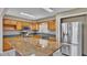 Kitchen with granite countertops, stainless steel appliances, and wood cabinets at 6110 Downing St, Dover, FL 33527
