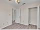 Spacious bedroom with wood-look flooring and ample closet space at 6110 Downing St, Dover, FL 33527