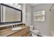 Updated bathroom with granite countertop, large mirror, and shower/tub combo at 6110 Downing St, Dover, FL 33527