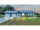 Ranch-style home with double garage and manicured lawn at 6110 Downing St, Dover, FL 33527
