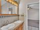 Double sink bathroom with wood cabinets and tile accents at 6110 Downing St, Dover, FL 33527