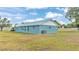 Blue house exterior with metal roof and large backyard at 6110 Downing St, Dover, FL 33527