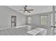 Bright living room featuring tile floors and a ceiling fan at 6110 Downing St, Dover, FL 33527