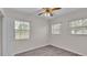Bright bedroom with wood-look flooring and ceiling fan at 6110 Downing St, Dover, FL 33527