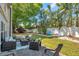 Landscaped backyard with multiple seating areas under mature trees, offering a relaxing outdoor space at 9945 47Th N Ave # 110, St Petersburg, FL 33708