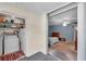 Laundry area with washer, dryer, and shelving located next to the bedroom with blue walls and ceiling fan at 9945 47Th N Ave # 110, St Petersburg, FL 33708