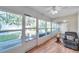 Enclosed sunroom featuring floor-to-ceiling windows, tile floors, and a ceiling fan overlooking the backyard at 9945 47Th N Ave # 110, St Petersburg, FL 33708