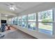 Sunroom with large windows overlooking the landscaped backyard seating area; features both wood floors and carpeting at 9945 47Th N Ave # 110, St Petersburg, FL 33708