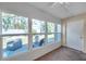 Enclosed sunroom with large windows providing natural light and views of the backyard seating area at 9945 47Th N Ave # 110, St Petersburg, FL 33708