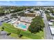 Aerial view showing a community pool, building, and surrounding landscape at 9945 47Th N Ave # 110, St Petersburg, FL 33708