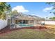 Large screened-in pool area with blue swimming pool and well-maintained lawn at 23338 Duchess Ave, Port Charlotte, FL 33954