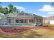 Backyard featuring a screened-in pool, mature trees, and lounge chairs for relaxation at 23338 Duchess Ave, Port Charlotte, FL 33954