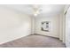 This bedroom features carpeted floors, a ceiling fan, a closet and a window at 23338 Duchess Ave, Port Charlotte, FL 33954
