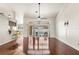 Bright and airy living room features hardwood floors, a ceiling fan, and backyard pool access at 23338 Duchess Ave, Port Charlotte, FL 33954