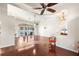Open-concept living room with hardwood floors, high ceilings, and views of the pool area at 23338 Duchess Ave, Port Charlotte, FL 33954