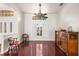 Bright living room boasts hardwood floors, neutral walls, and a stylish ceiling fan for comfortable living at 23338 Duchess Ave, Port Charlotte, FL 33954