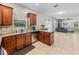 Kitchen with wood cabinets, stainless steel appliances and view into living room at 2745 Walden Woods Dr, Plant City, FL 33566