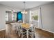 Bright dining room features a wood table with white chairs, hardwood floors, and an open floor plan at 2745 Walden Woods Dr, Plant City, FL 33566