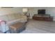 Living room with sofa, ottoman, and TV at 1345 Drew St # 1, Clearwater, FL 33755