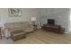 Living room with sofa, ottoman, and TV at 1345 Drew St # 1, Clearwater, FL 33755