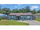 Quaint gray house with a fenced yard and driveway at 4308 S Trask St, Tampa, FL 33611