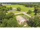 Aerial view of a ranch style home with a large yard and surrounding farmland at 2209 Jerri Lynn Ct, Plant City, FL 33567