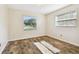 Simple bedroom with wood-look floors and a window with blinds at 2209 Jerri Lynn Ct, Plant City, FL 33567