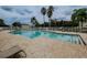 Community pool with lounge chairs and surrounding landscaping at 731 Ashentree Dr, Plant City, FL 33563