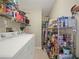 Functional laundry room with washer, dryer, and storage shelves at 10507 Goldwater Ln, Riverview, FL 33569