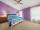 Spacious main bedroom with light purple walls and a comfortable bed at 10507 Goldwater Ln, Riverview, FL 33569