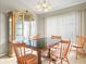 Bright dining room features a dark-top table with wood chairs and a large glass-front cabinet at 10507 Goldwater Ln, Riverview, FL 33569