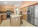 Kitchen boasts stainless steel appliances and light wood cabinets at 10507 Goldwater Ln, Riverview, FL 33569