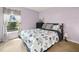 Bedroom with a floral comforter and window view at 10507 Goldwater Ln, Riverview, FL 33569