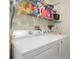 Bright laundry room with washer, dryer, and overhead storage at 10507 Goldwater Ln, Riverview, FL 33569