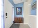 Bright entryway with blue walls and wood storage at 10507 Goldwater Ln, Riverview, FL 33569