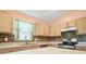 Kitchen with light wood cabinets, stainless steel appliances, and a stylish backsplash at 10507 Goldwater Ln, Riverview, FL 33569