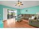 Relaxing living room with hardwood floors, vaulted ceiling and sliding doors to patio at 10507 Goldwater Ln, Riverview, FL 33569