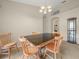 Simple dining room with a dark-top table and four wooden chairs at 10507 Goldwater Ln, Riverview, FL 33569