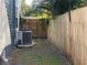 Side yard with AC unit and wooden fence at 6704 N 13Th St, Tampa, FL 33604