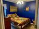 Bedroom with double bed and blue walls at 6704 N 13Th St, Tampa, FL 33604