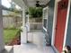 Inviting front porch with white railings and ceiling fan at 6704 N 13Th St, Tampa, FL 33604